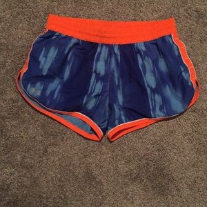 Blue and orange Under Armour running shorts